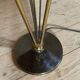 Vintage black metal and brass floor lamp with three white opal shades.