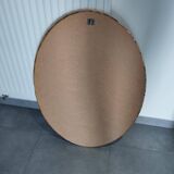 Large and elegant oval gilded mirror with its beveled glass