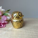 Old small black and gold lacquered wooden box in the shape of an owl
