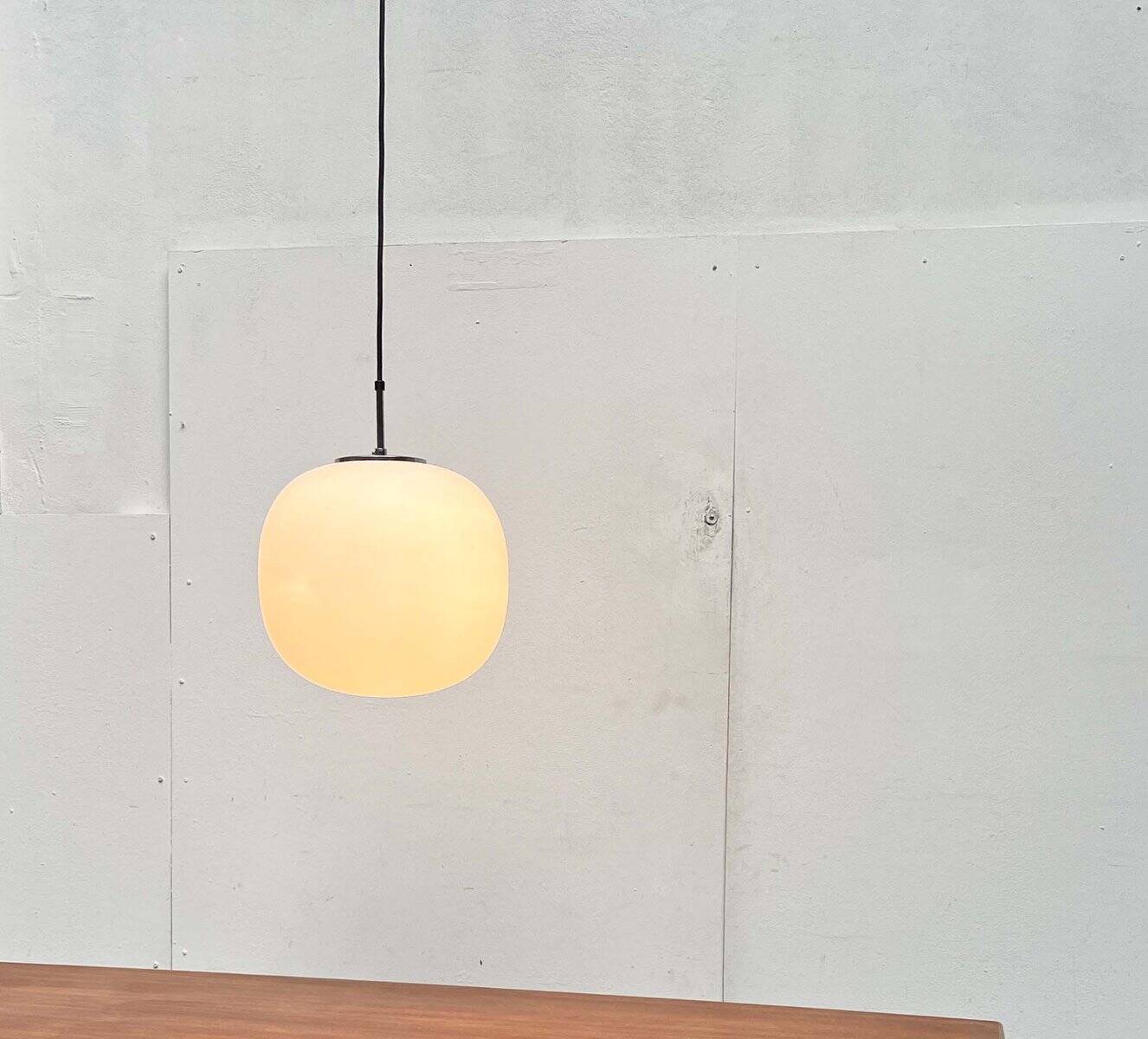 Minimalist suspended glass ball lamp from the vintage German space age by Glashütte Limburg, 1970s.