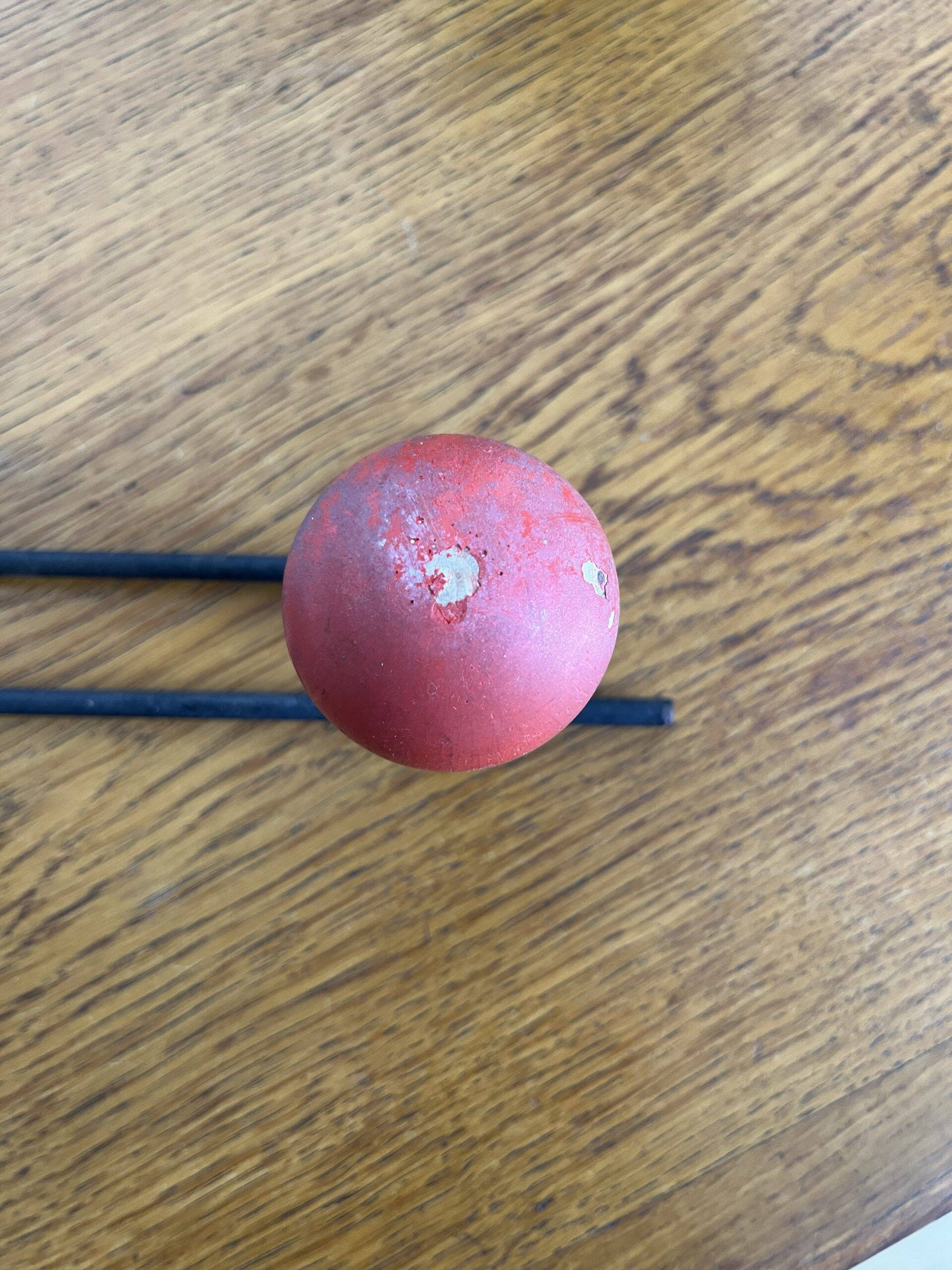 Coat rack with 3 red wooden balls