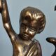 Pair of antique candlesticks in cherub bronze