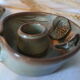 Pair of cellar rat candle holders in glazed sandstone