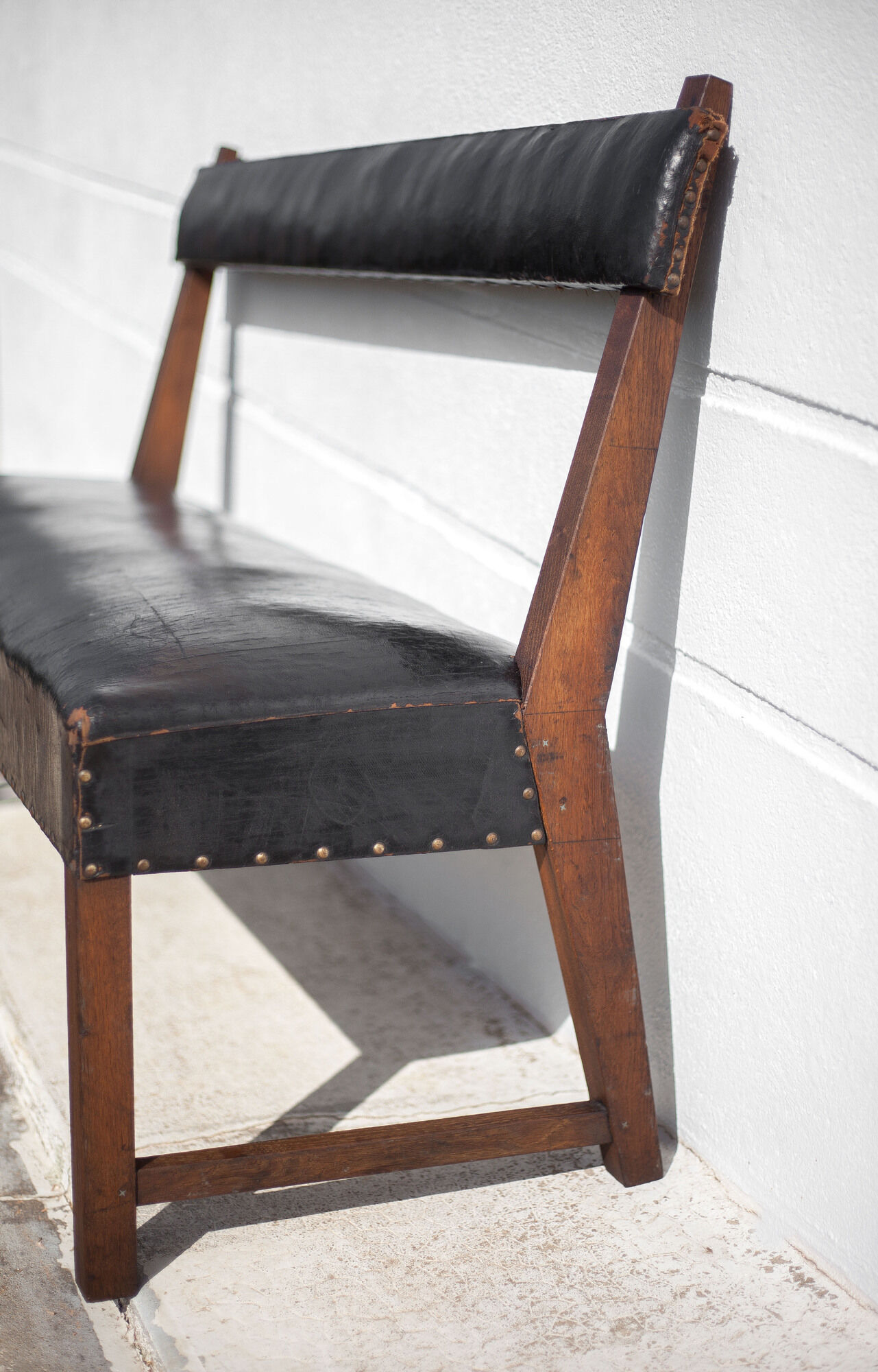 Antique wood bench and black imitation leather
