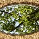 Bevelled oval mirror, richly crafted Art Deco wrought iron.
