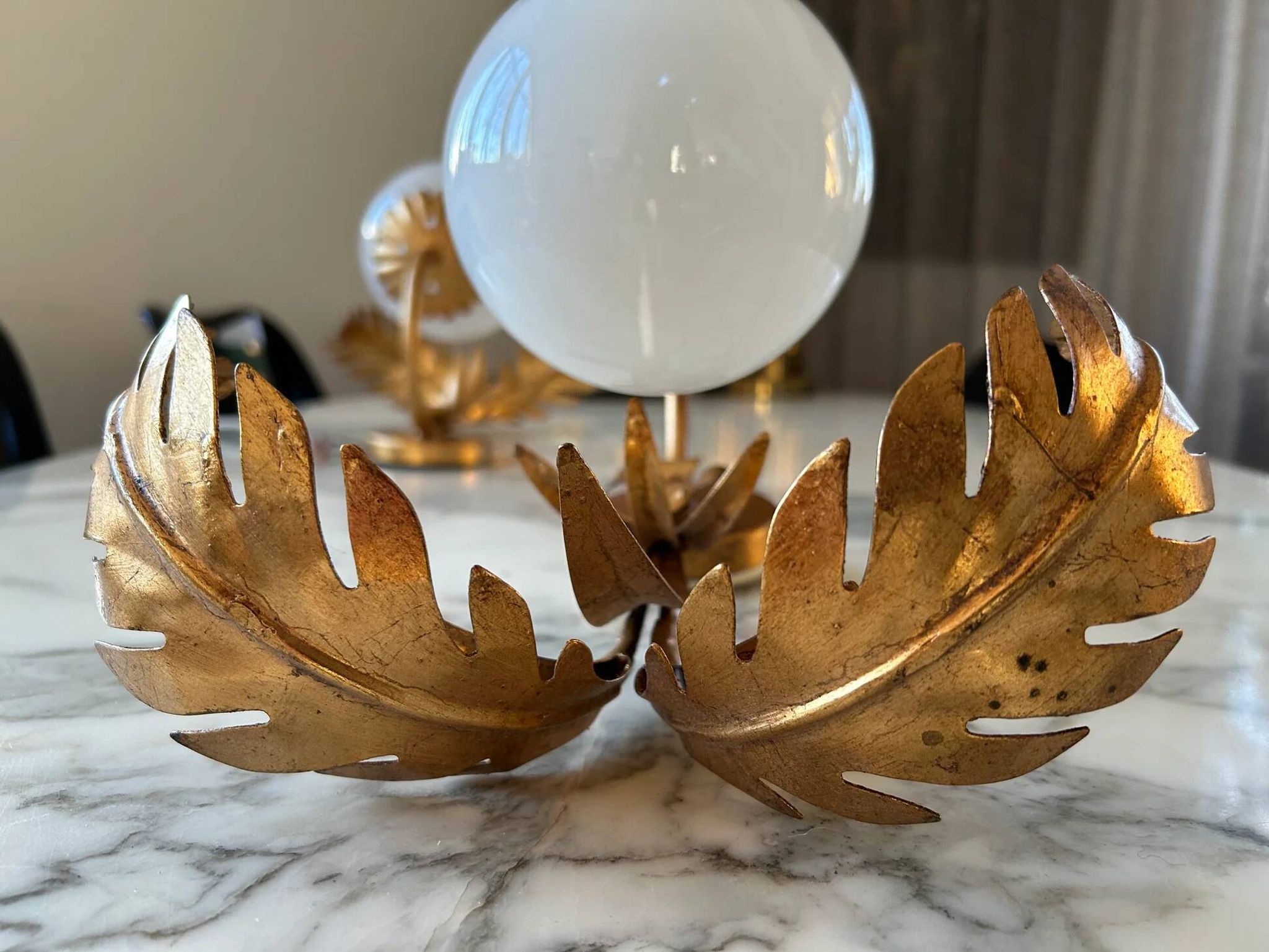 Pair of palm leaf wall lights in Hollywood Regency style with opaque globes by Hans Kögl, Germany, 1970s.
