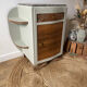 Pair of mismatched art deco bedside tables in green and wood