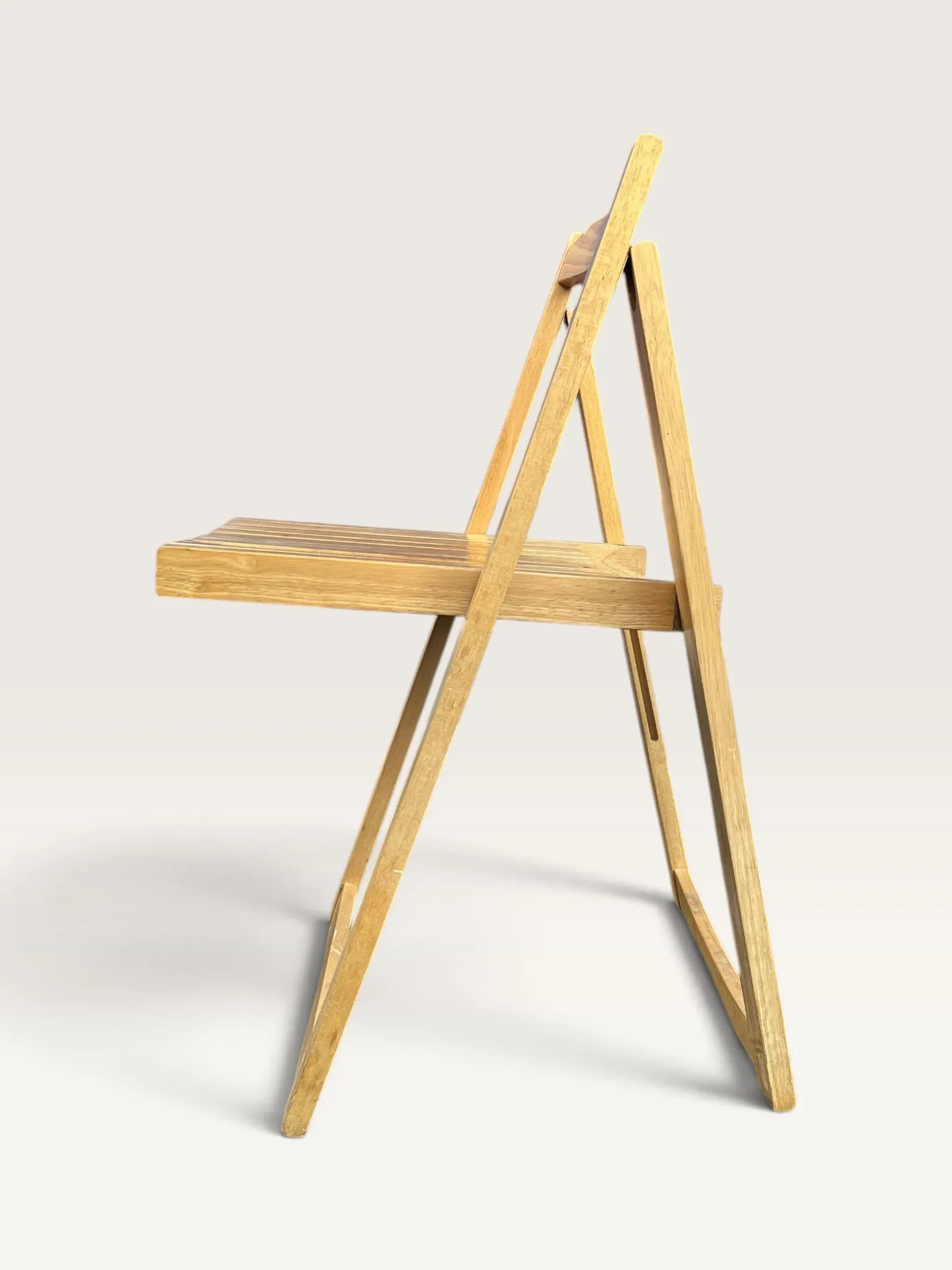 Blonde wooden folding chair in the style of Aldo Jacober.