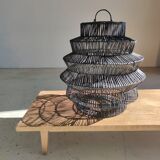 Braided rattan suspension in the shape of a black accordion