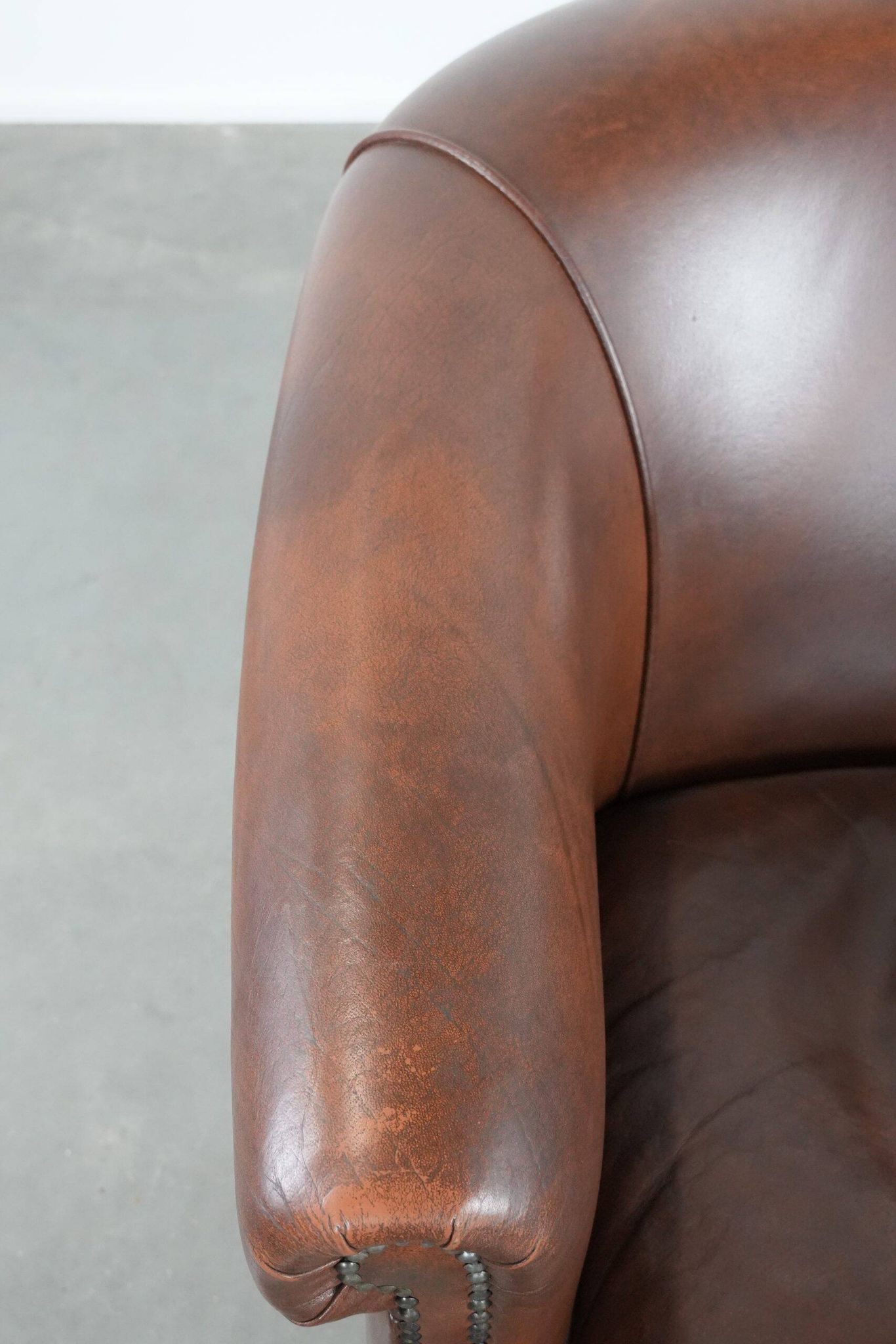 Cognac-coloured cow leather club armchair in English style