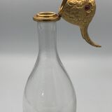 Glass bottle type carafe with gold metal bird head stopper