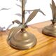 Pair of brass candlesticks with plant decoration