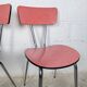 Pair of red Formica chairs with chrome legs