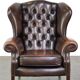 Chesterfield wing chair in dark brown leather with a luxurious appearance