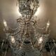 A pair of imposing, antique chandeliers with pendants.