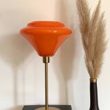 Table lamp with a vintage orange glass globe and a gold base