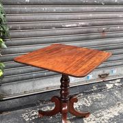19th-century solid mahogany table with a tilting top and brass mechanism.