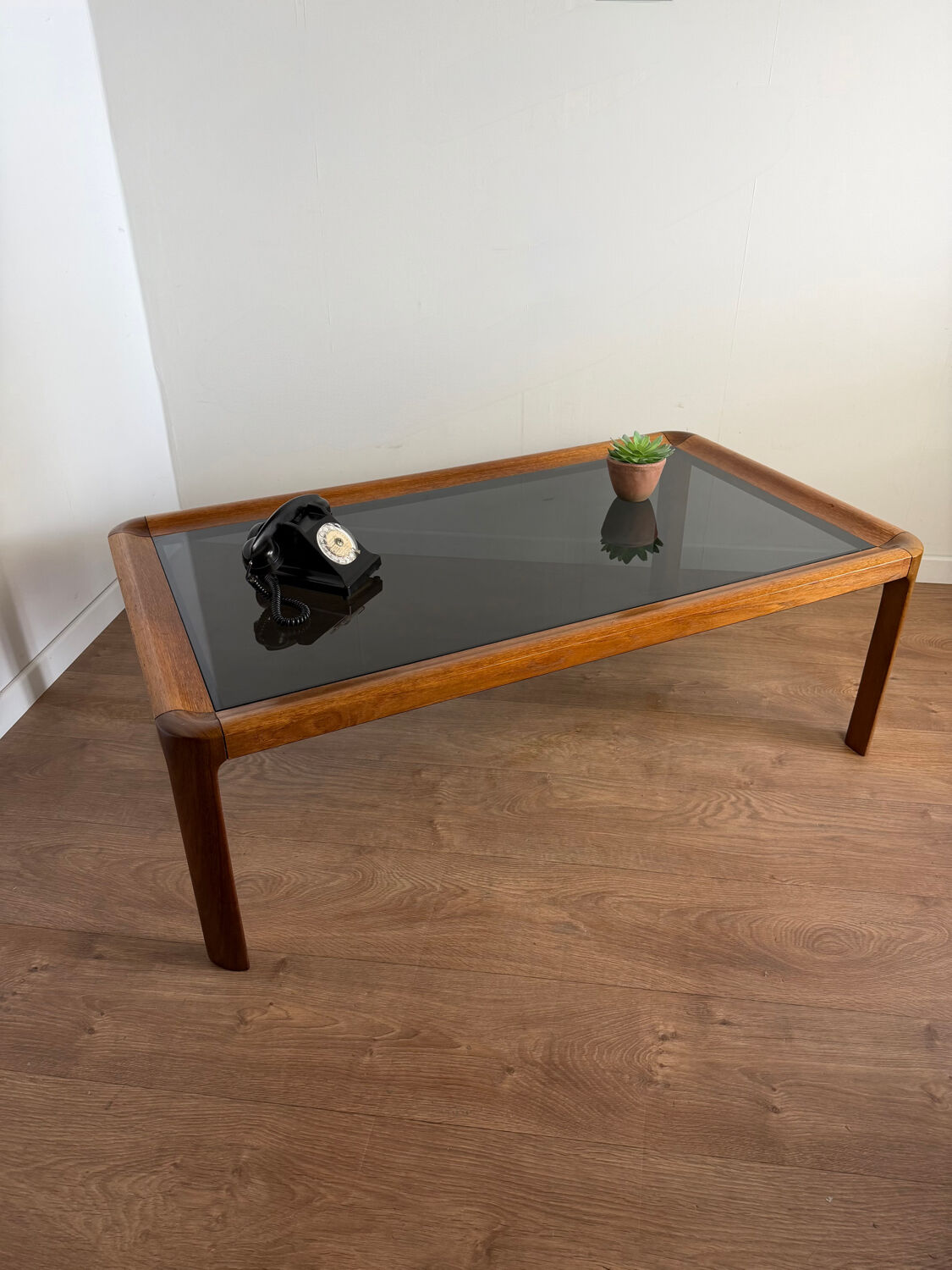 Large Scandinavian coffee table in teak and smoked glass.