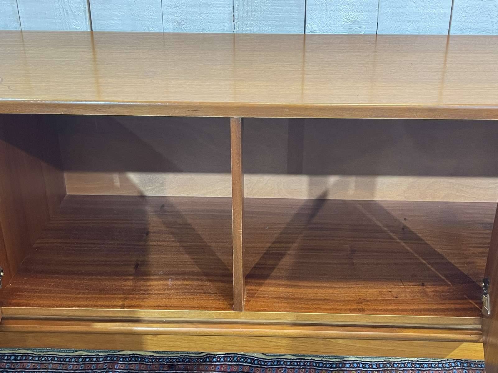 1970s English enfilade in teak with splayed legs.