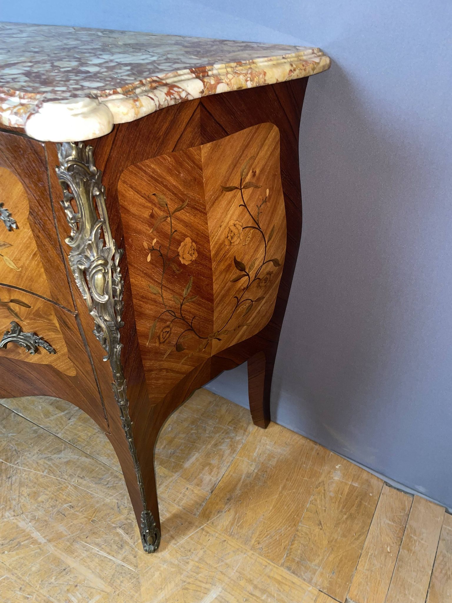 Louis XV style commode with floral marquetry decoration.