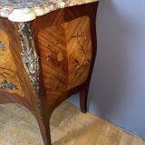 Louis XV style commode with floral marquetry decoration.