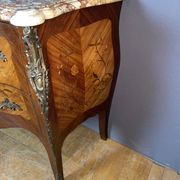 Louis XV style commode with floral marquetry decoration.