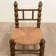Low chair in beaded wood and straw