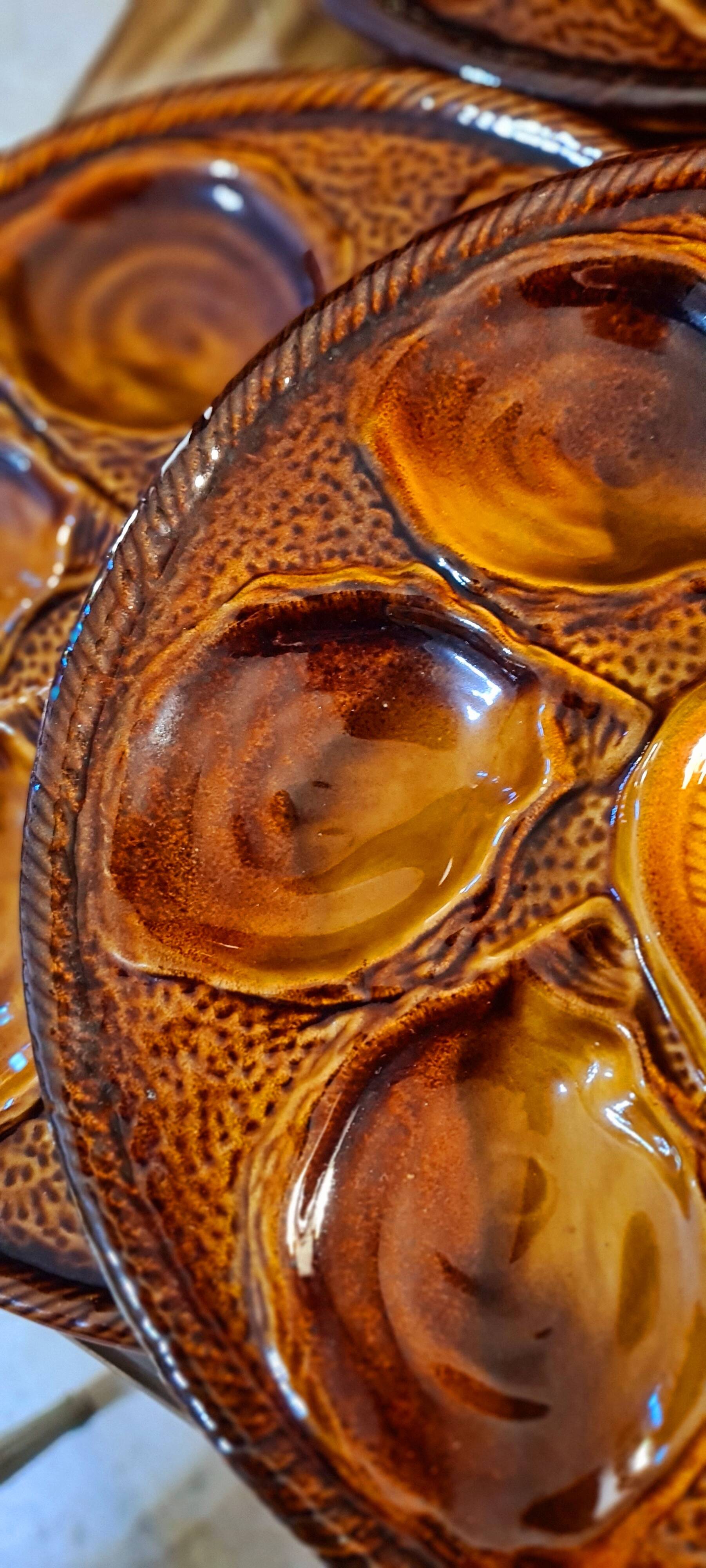 Six oyster plates signed Saint Clément