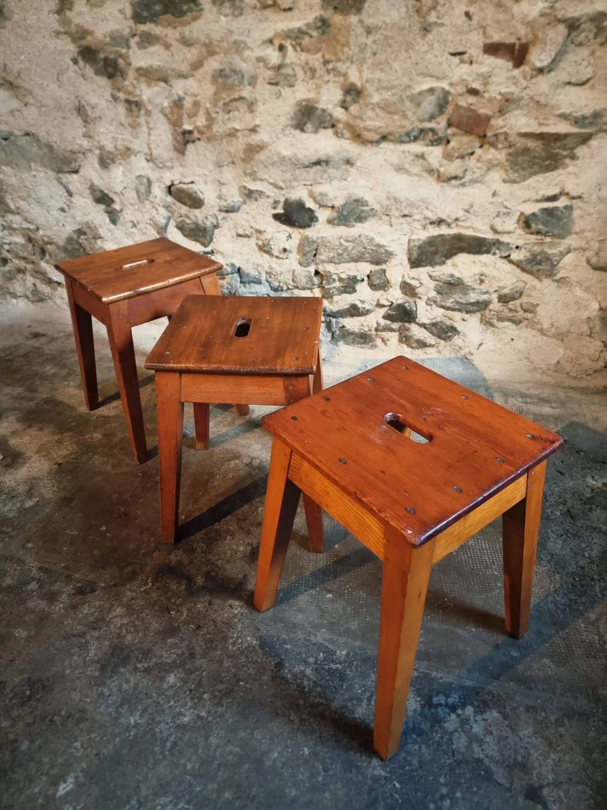 Set of 3 vintage French wooden stools from the 1950s.