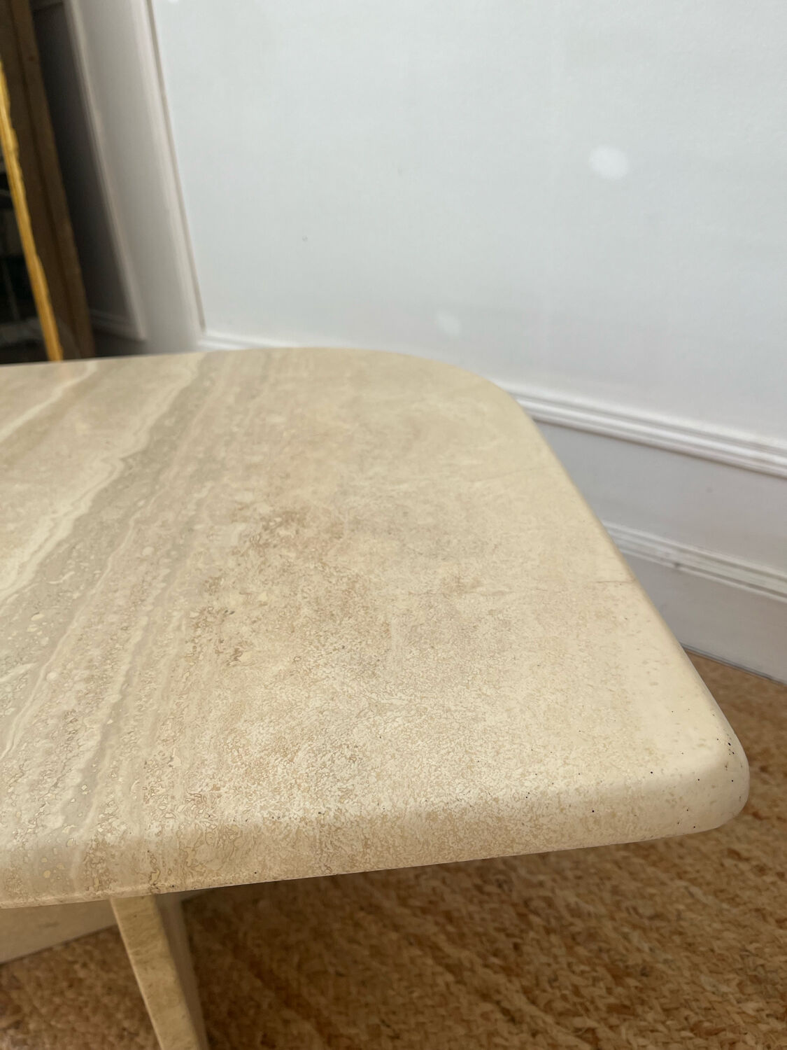 Travertine coffee table in eye shape.