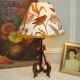 Rock-style table lamp with its vintage bird pattern shade