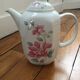 Vintage porcelain coffee or teapot with milk jug