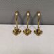 Three old and beautiful brass hooks with decorative motifs