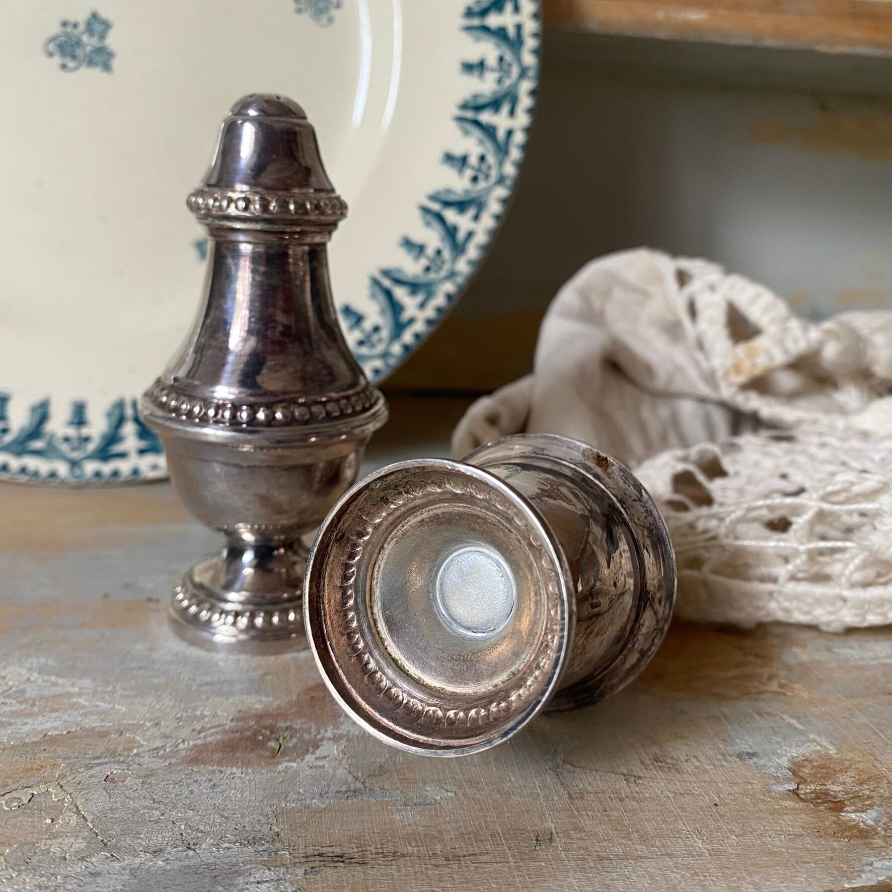 Silver-plated salt and pepper shakers, fluted, beaded decoration.