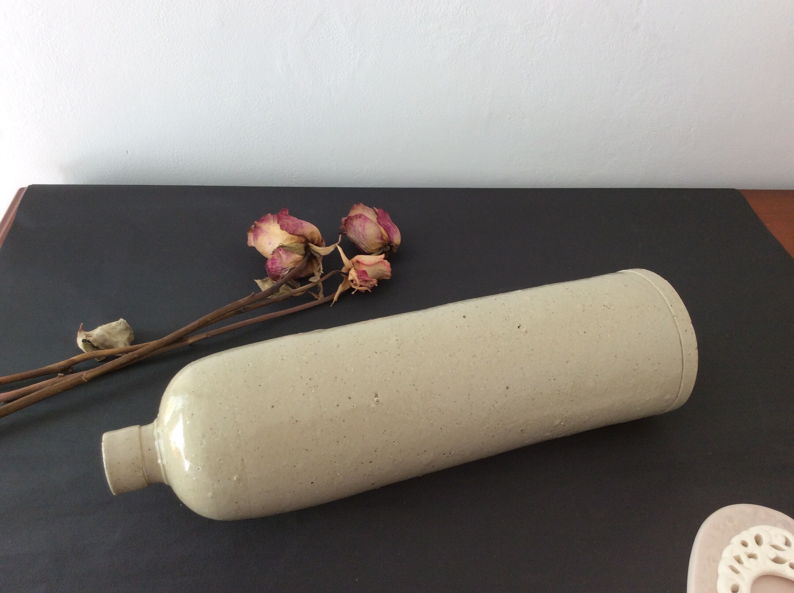 Old stoneware bottle with ear, loop
