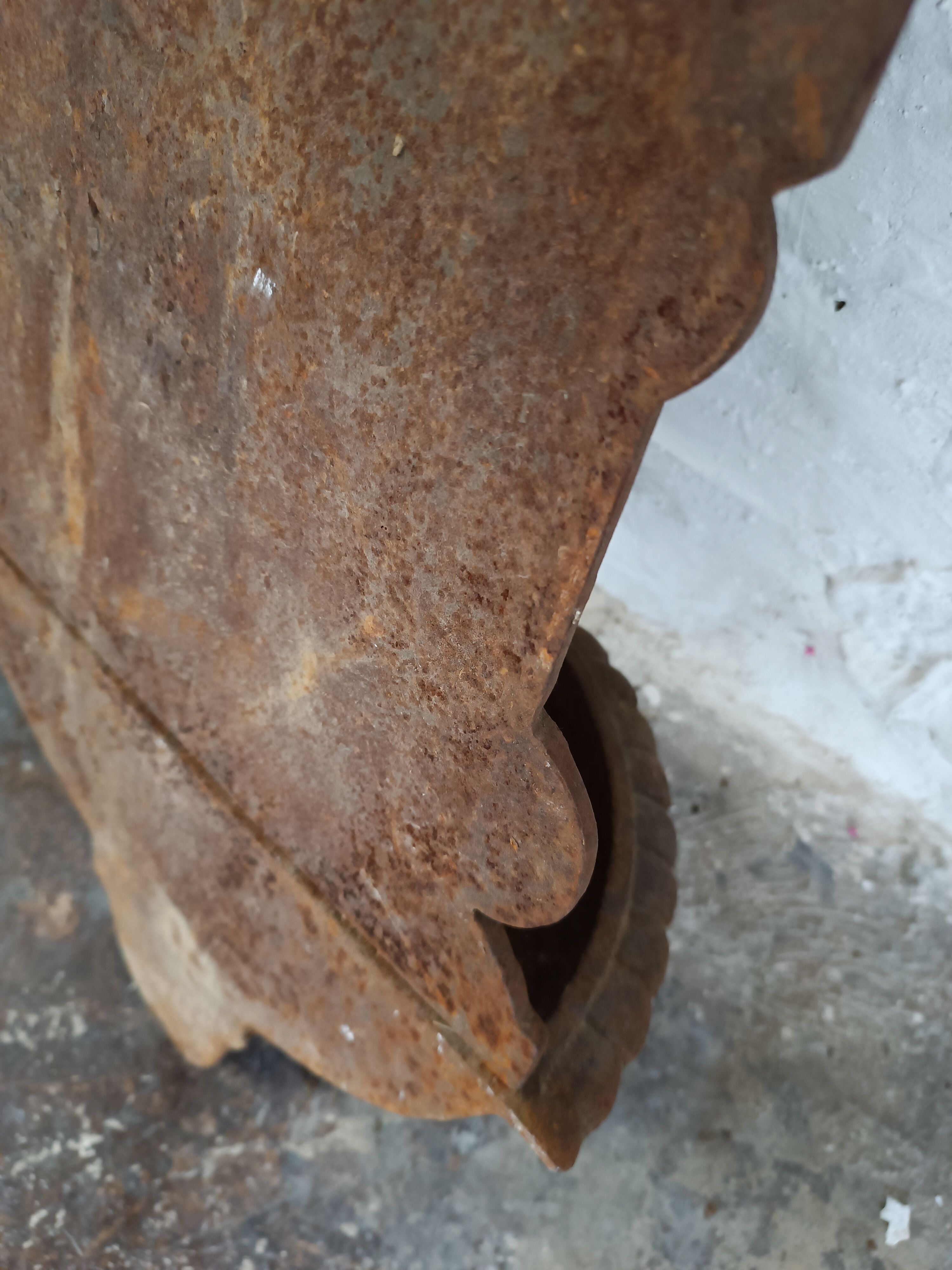 Old cast iron wall fountain with lion's head