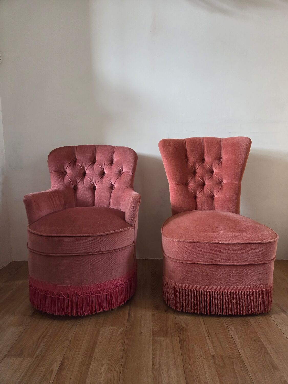 A pair of small tub chairs.