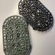 Duo of antique cast iron table mats