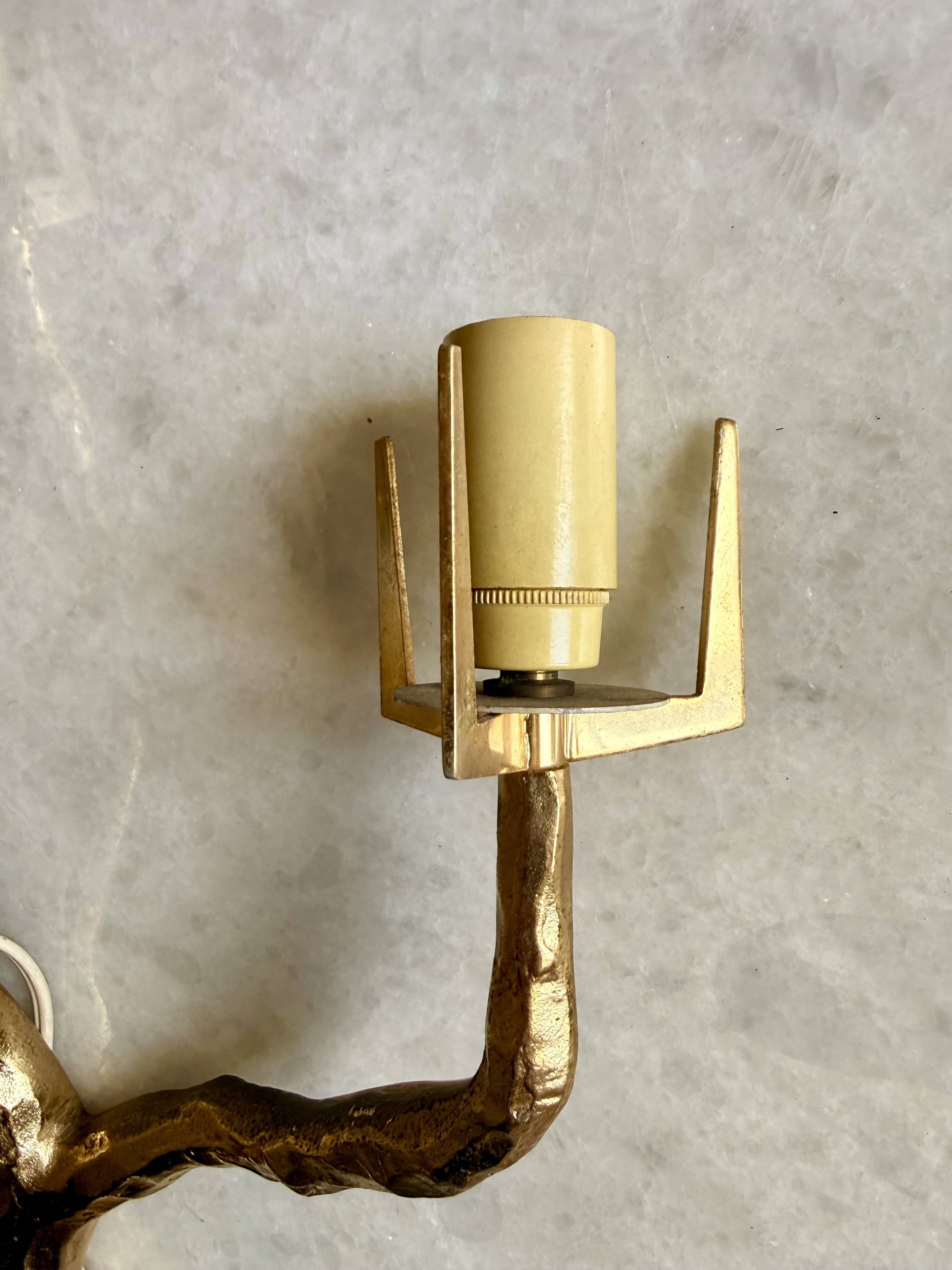 Pair of wall lights by Maison Arlus by Felix Agostini in bronze.