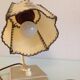 Brass bedside lamp and beige lampshade art deco style