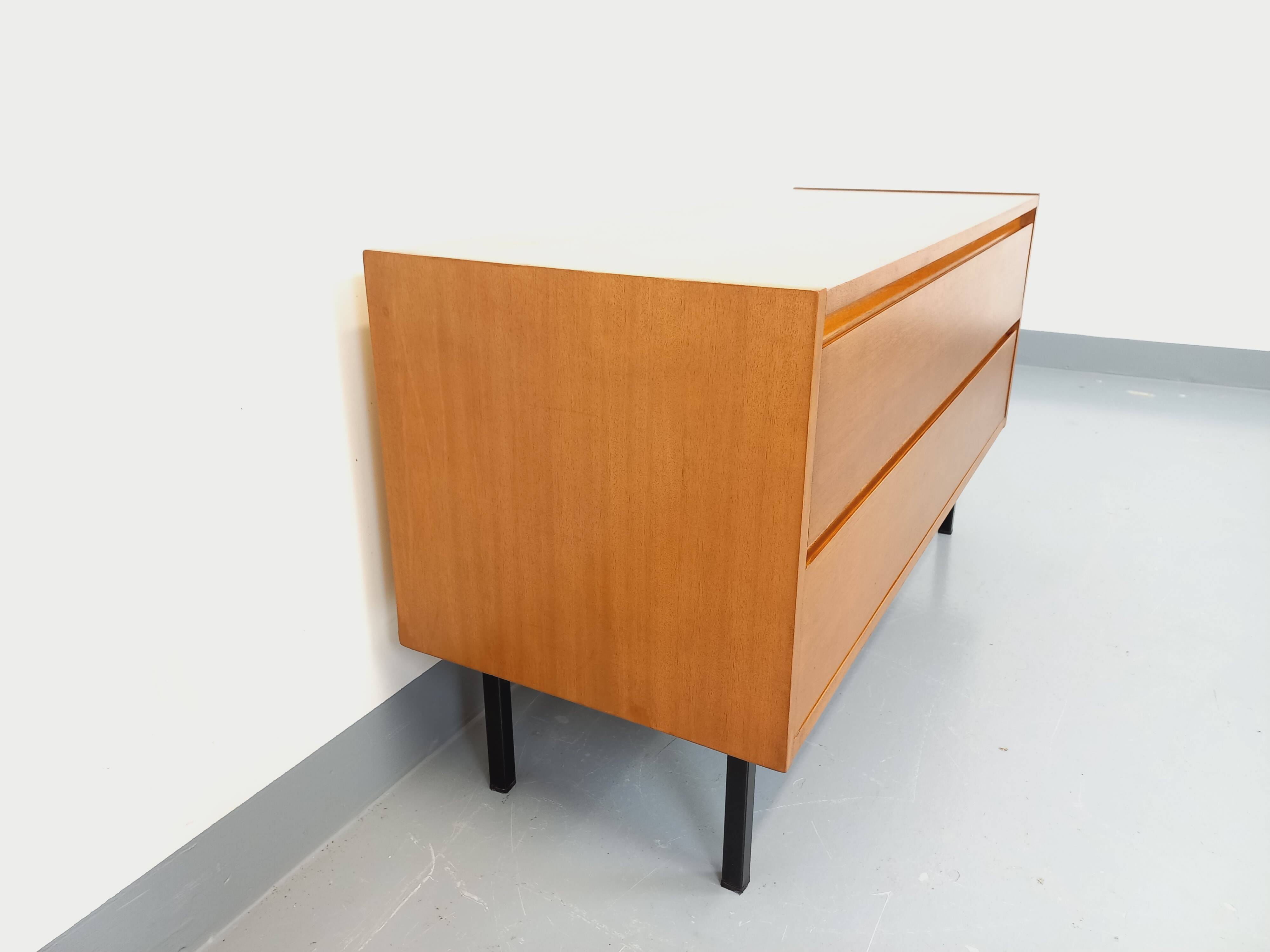 Small vintage Scandinavian sideboard in modernist style made of light oak wood.