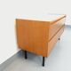 Small vintage Scandinavian sideboard in modernist style made of light oak wood.