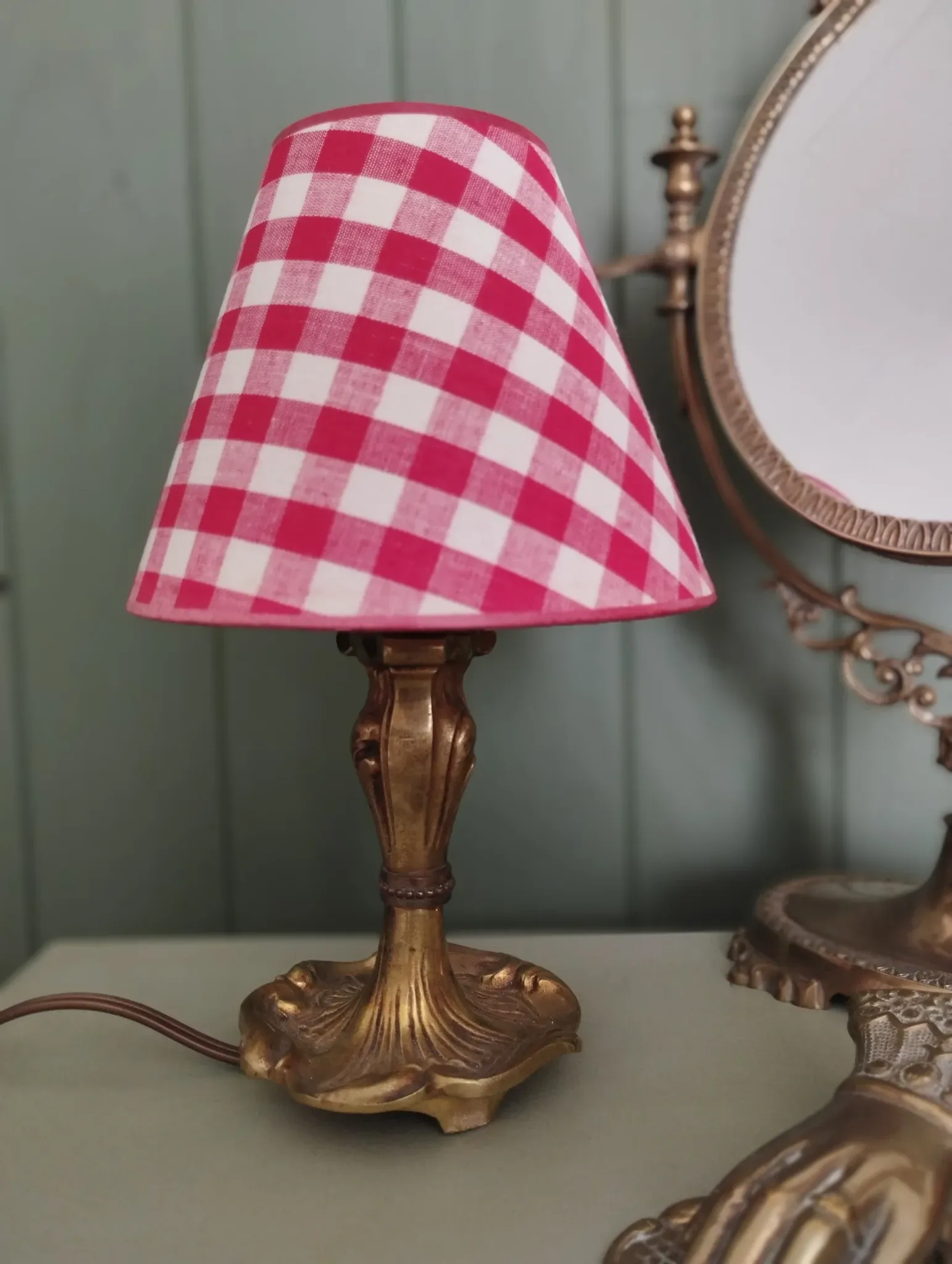 Pair of small lamps in gilded bronze by Petitot and red gingham lampshades.