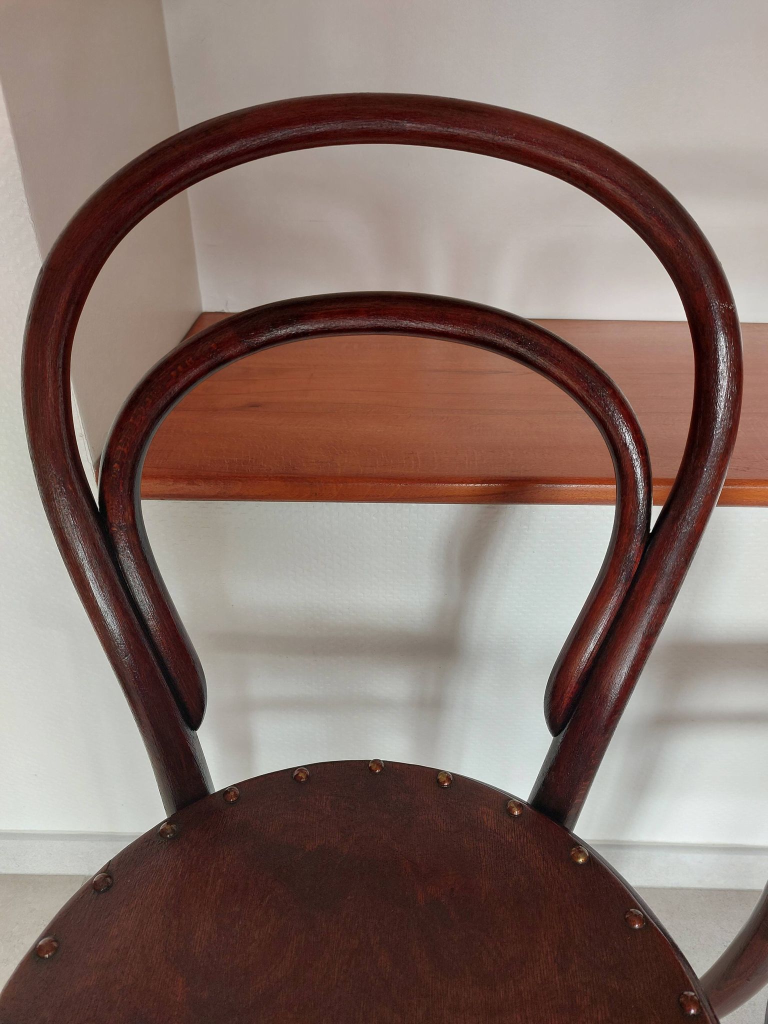 pair of round bistro chairs with a pattern on the seat, vintage