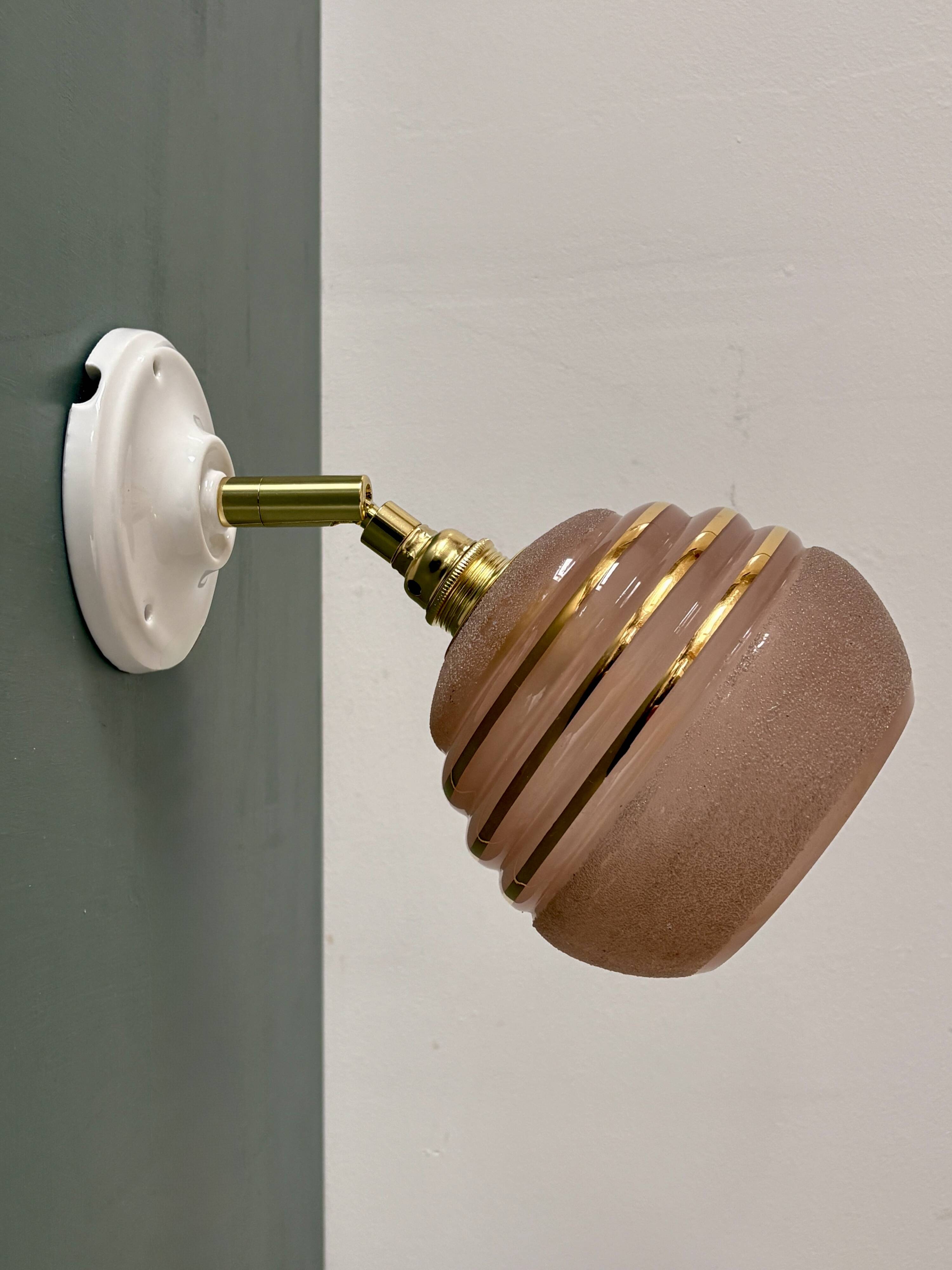 Vintage globe wall light in frosted pink and gold glass.