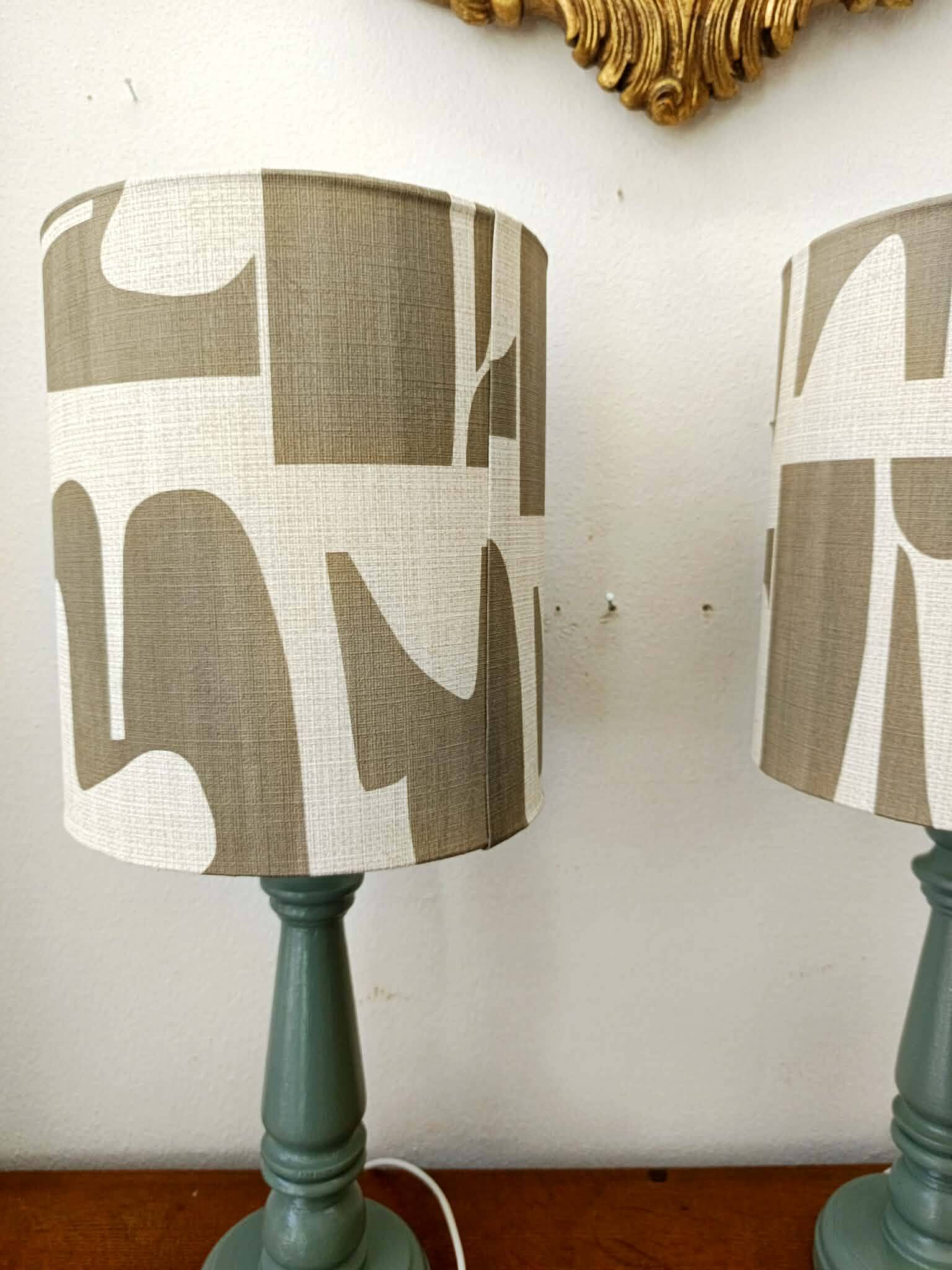 Pair of wooden lamps with custom modernist lampshades.