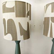 Pair of wooden lamps with custom modernist lampshades.