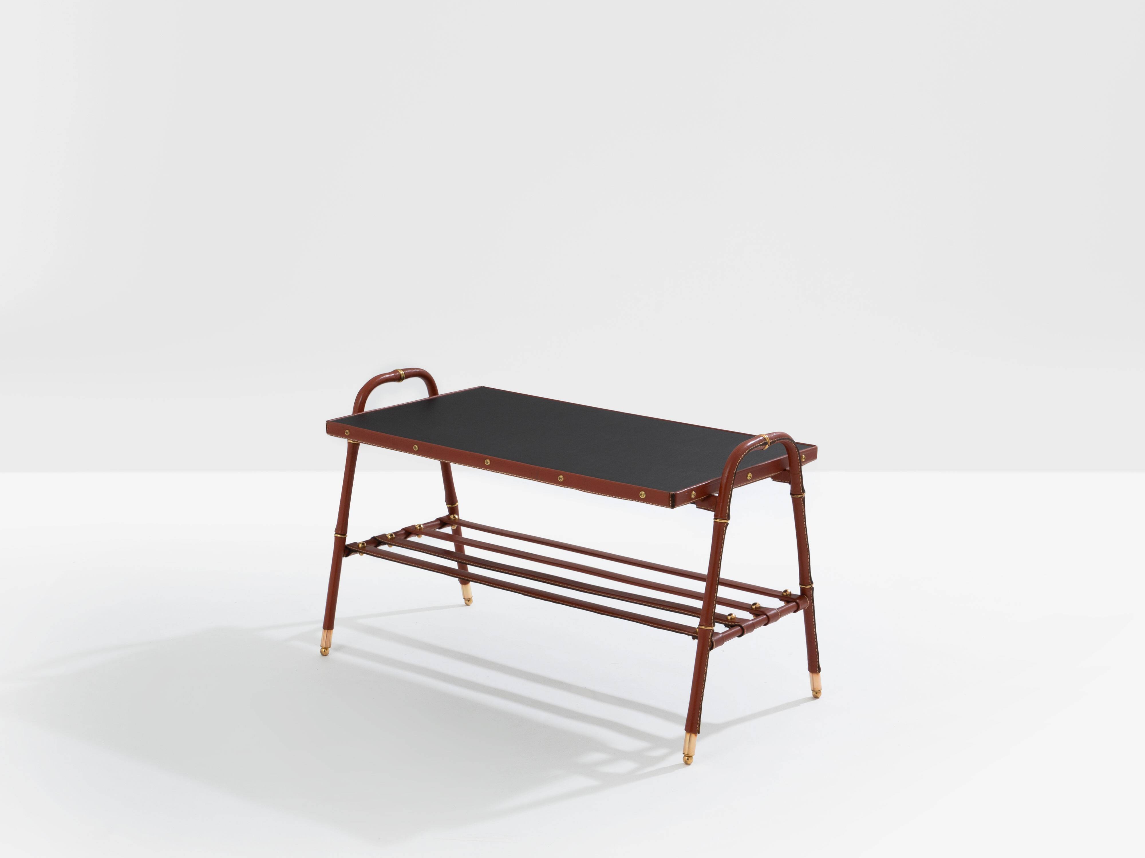 Jacques Adnet coffee table in red saddle-stitched leather and brass, 1950s