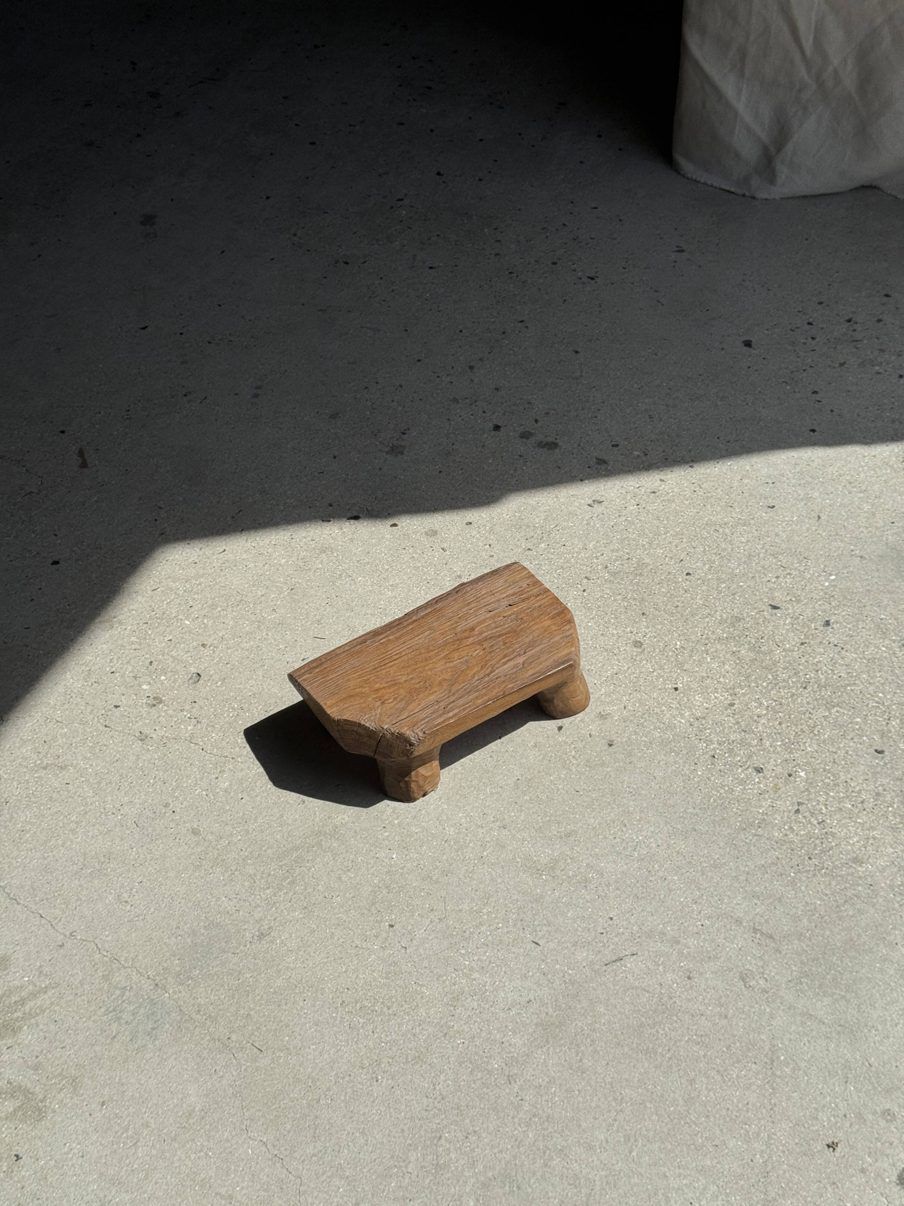 Small stool, teak footrest with short cut corners.