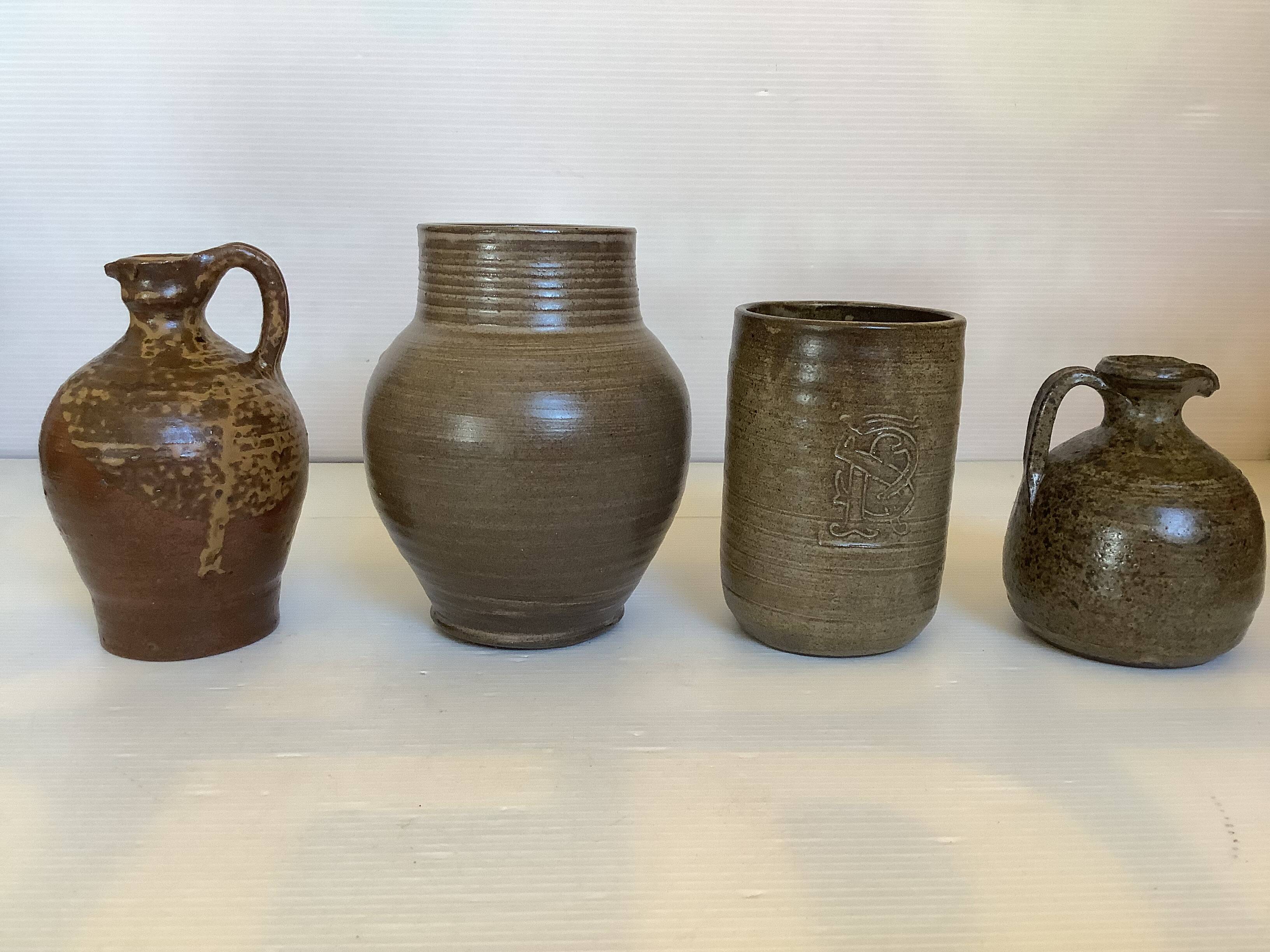 Eight brown ceramic pitcher vases